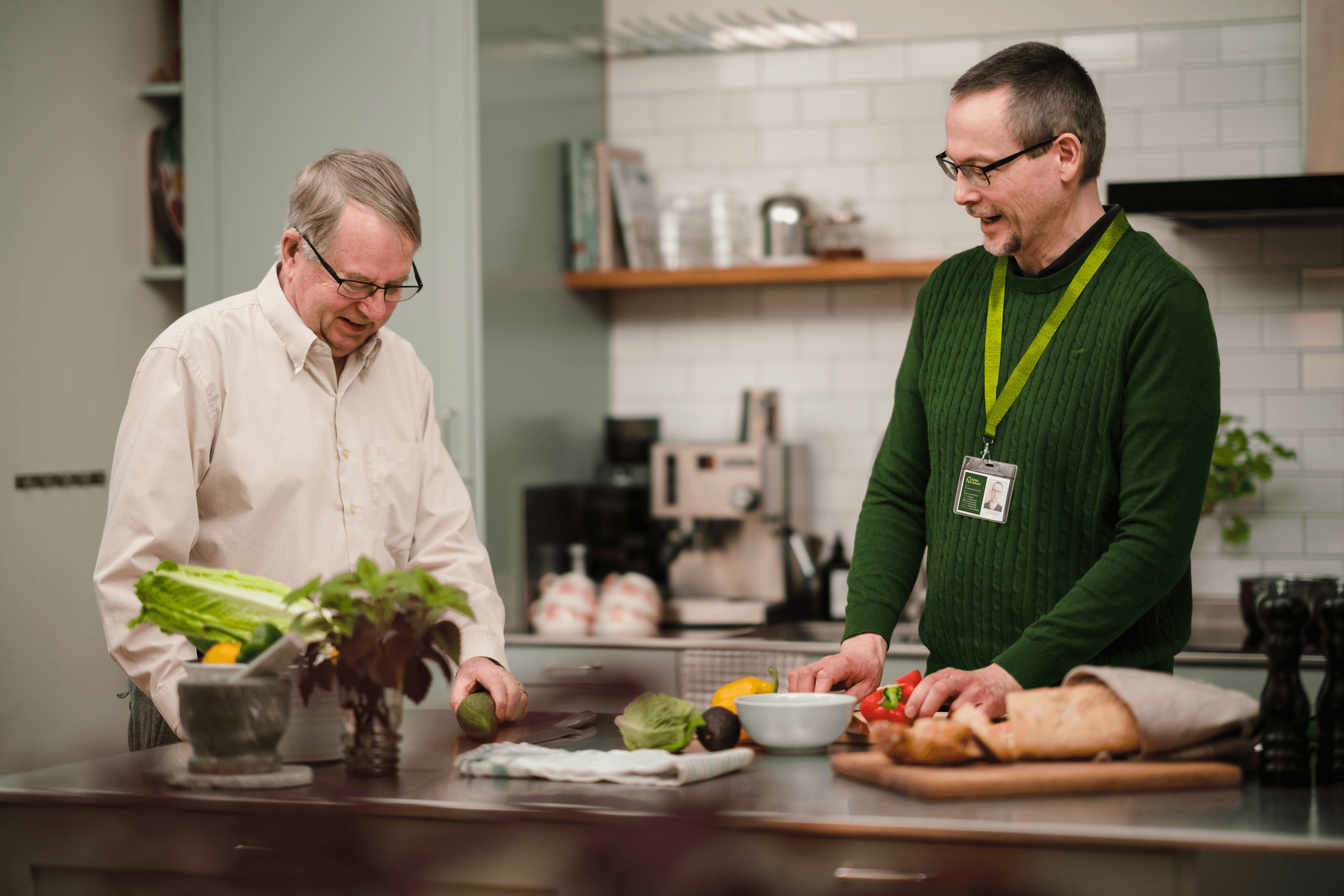 male client and male care professional chatting in the kitchen
