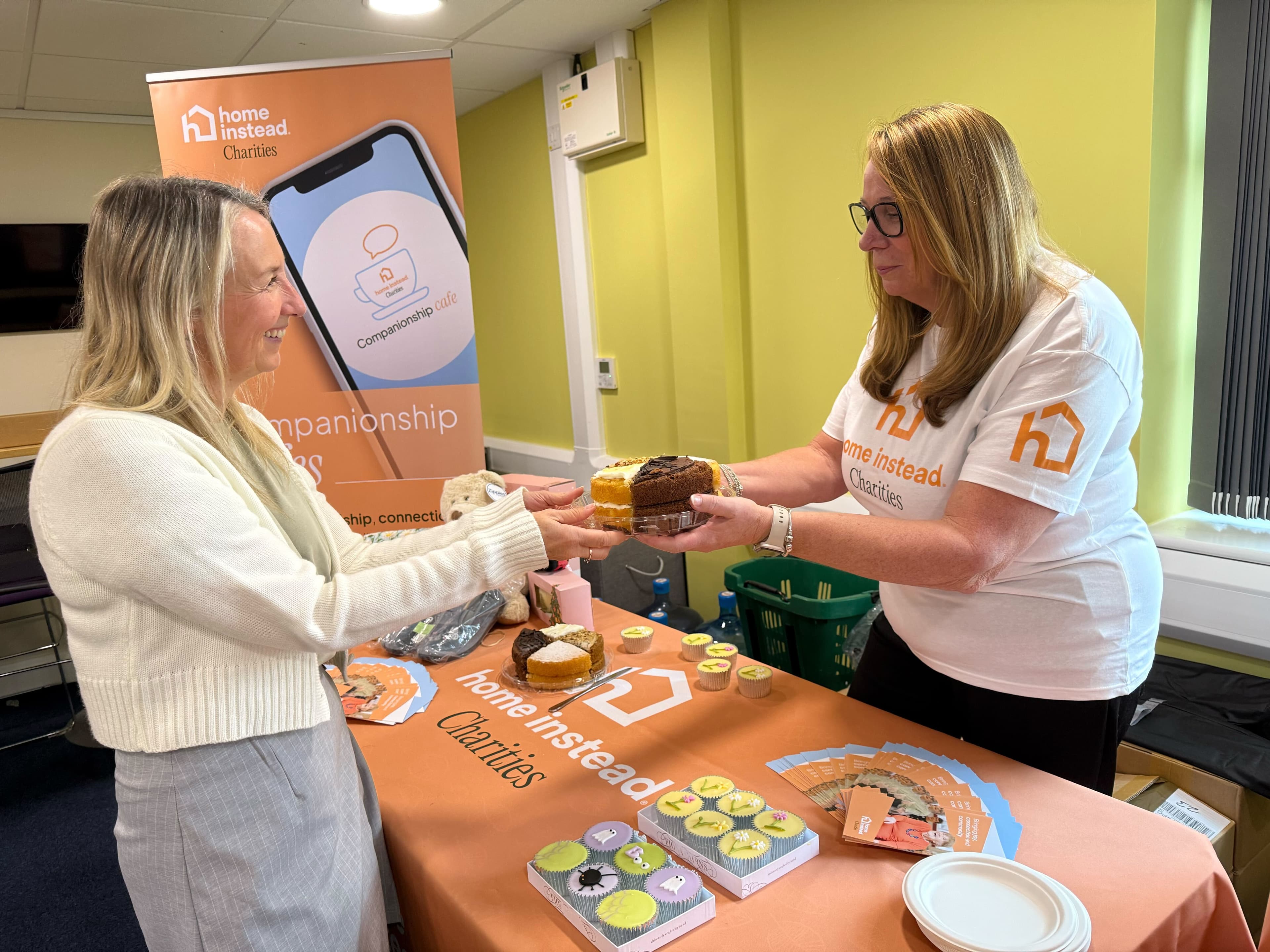 Two women at a Home Instead charities stall