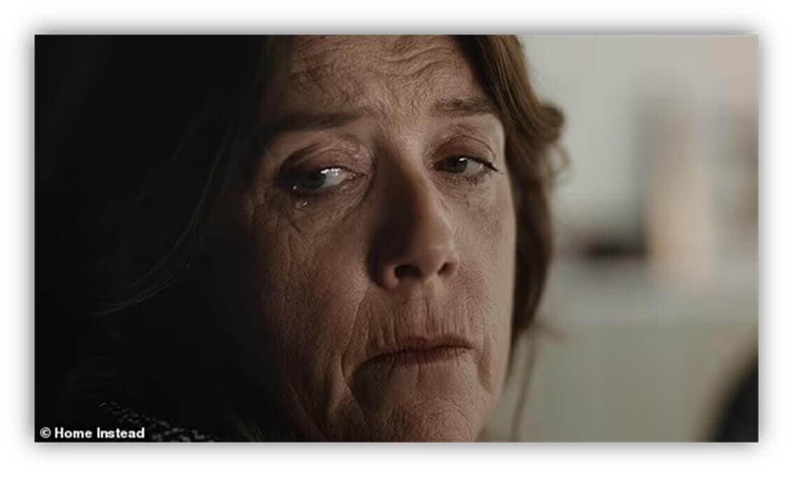 Close-up of a woman with brown hair looking sad and thoughtful, with tears in her eyes. - Home Instead