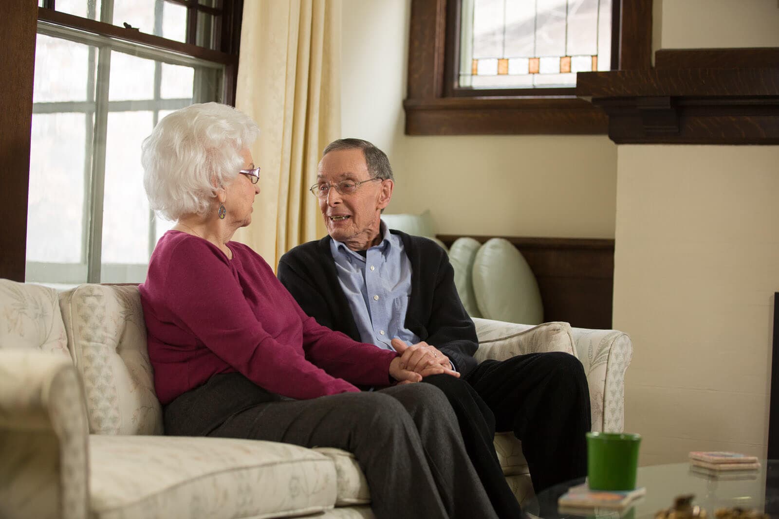 Home Instead clients sitting together on the sofa at home