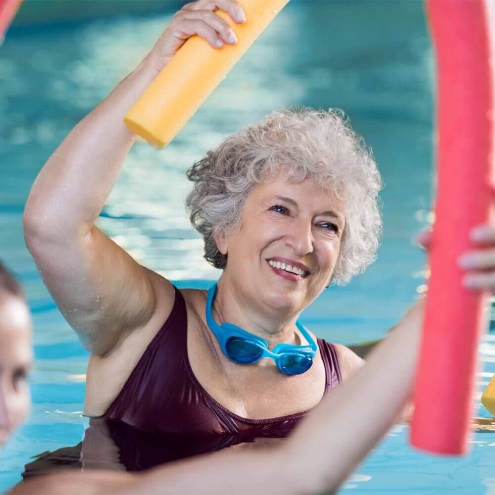 older lady enjoying aqua aerobics in a swimming