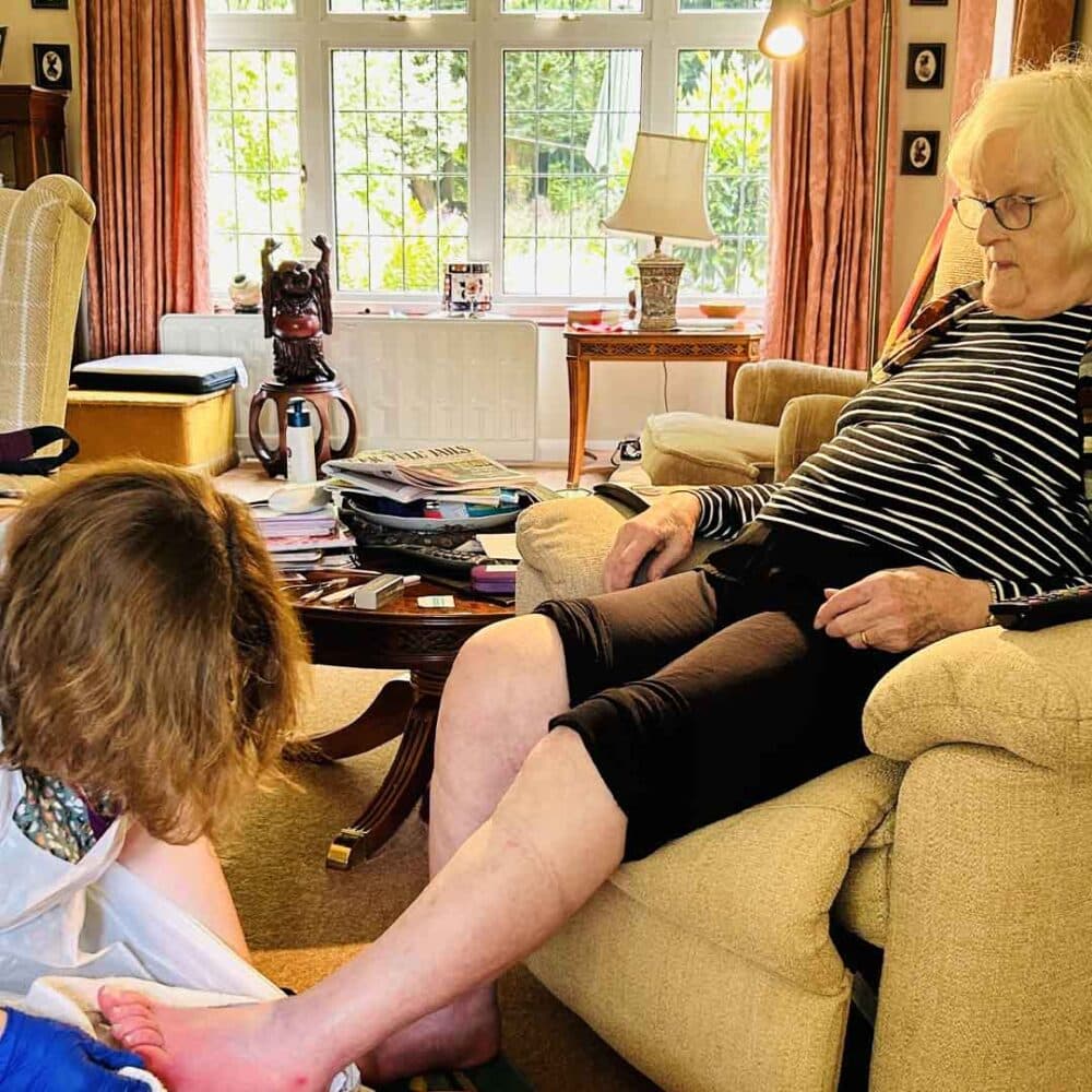 Liz Thew having her feet dried as part of a home nail care session from Home Instead