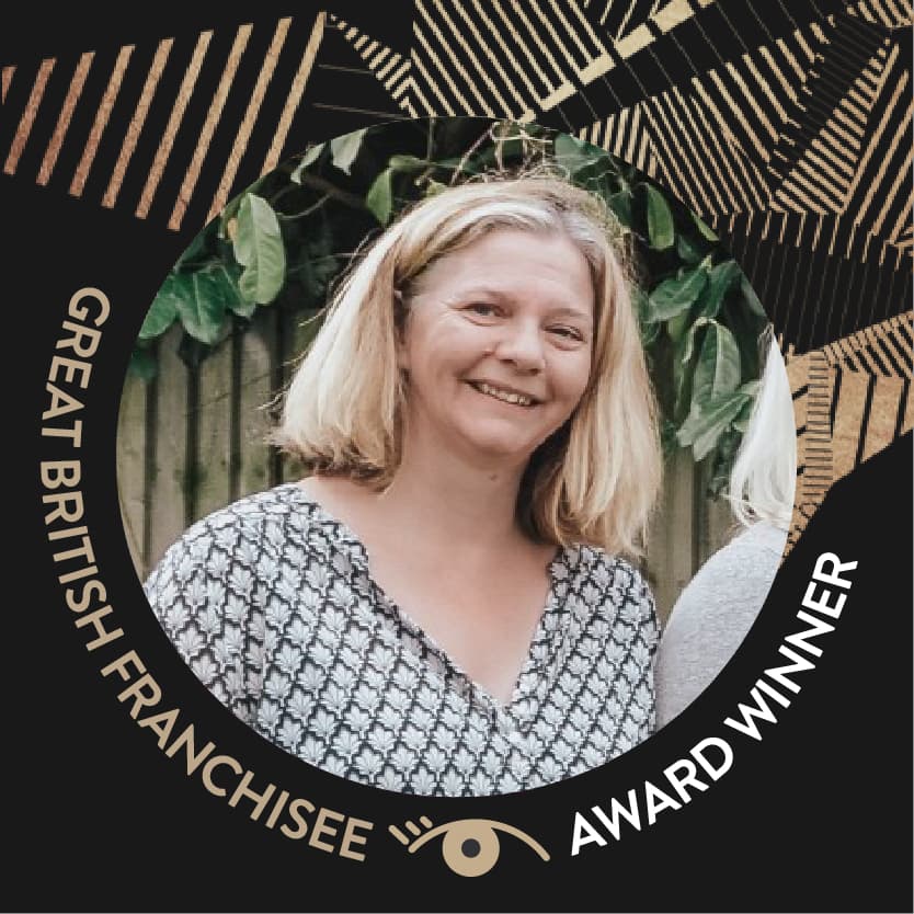 Smiling woman with blonde hair, "Great British Franchisee Award Winner" text in a decorative circular frame. - Home Instead