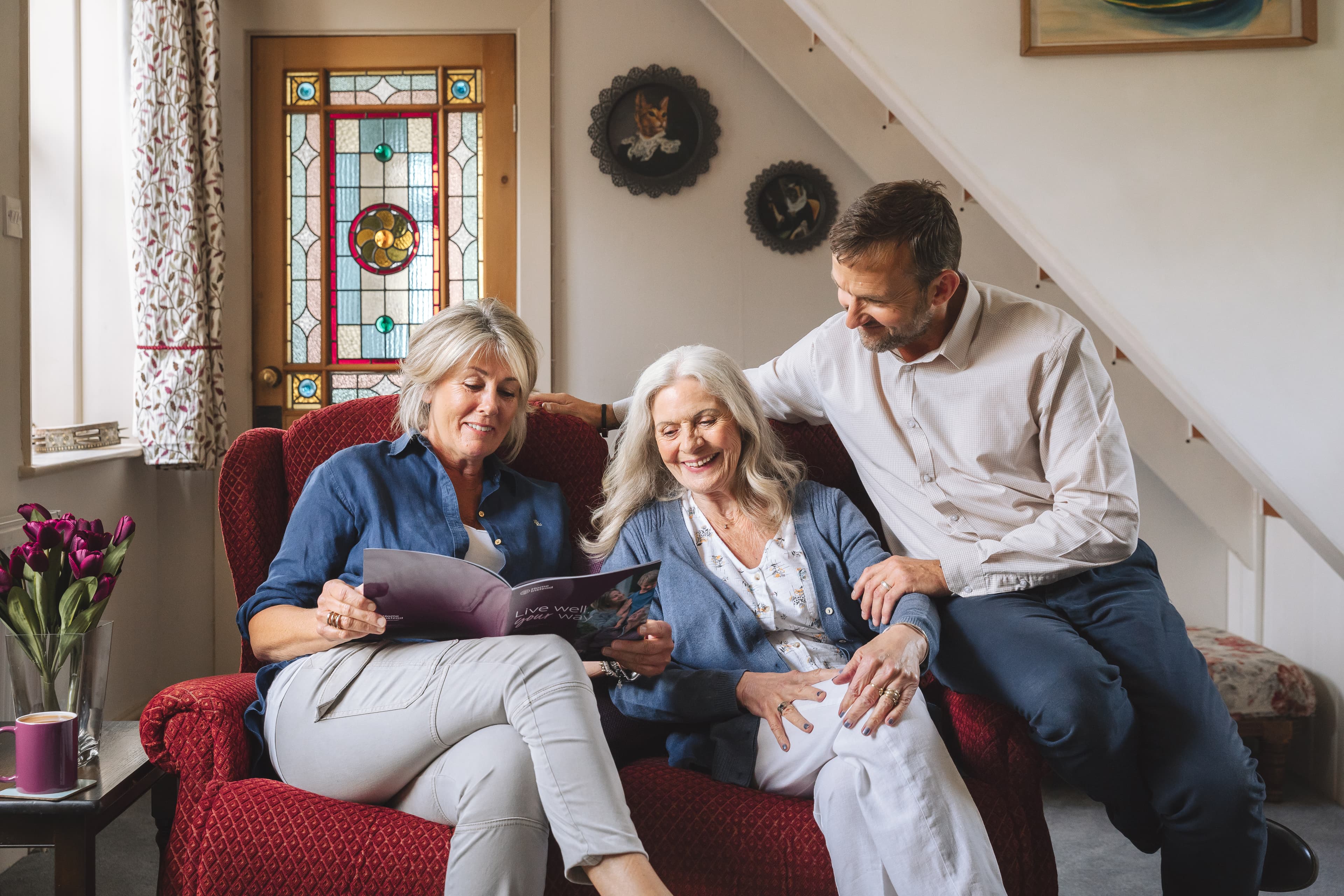 Smiling Mother and children reading brochure - Home Instead