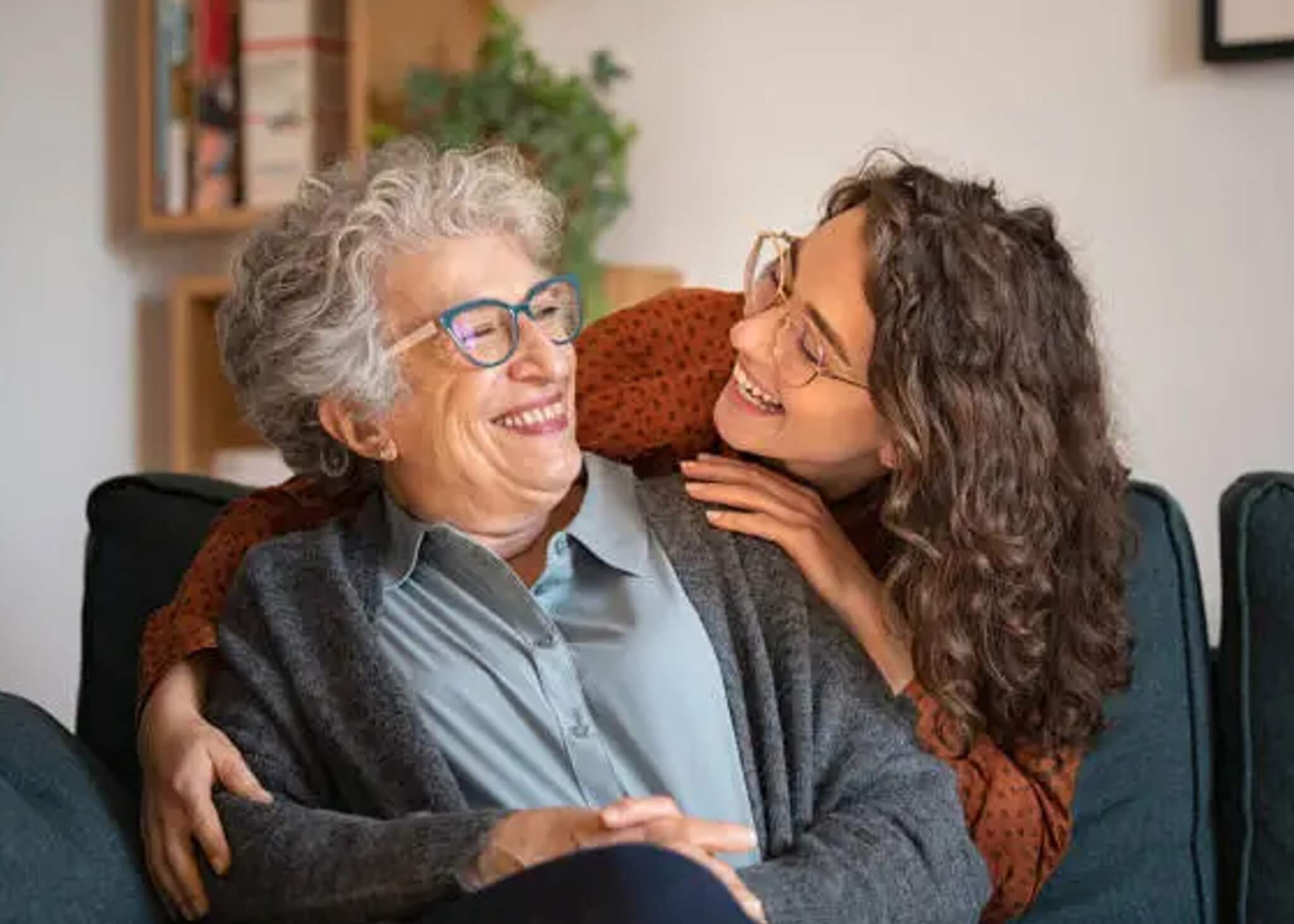 Daughter and mother smile together, enjoying their bond and working together through the challenges of communicating when someone is living with dementia