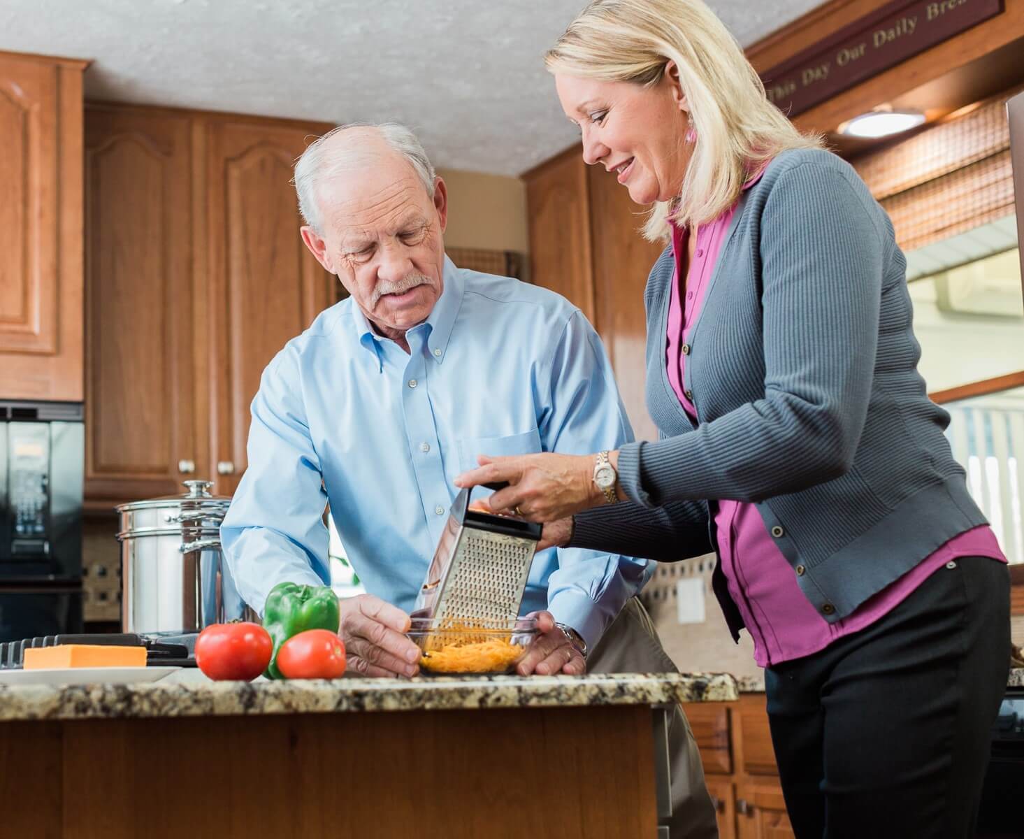 Home Instead carer and her client preparing a meal together