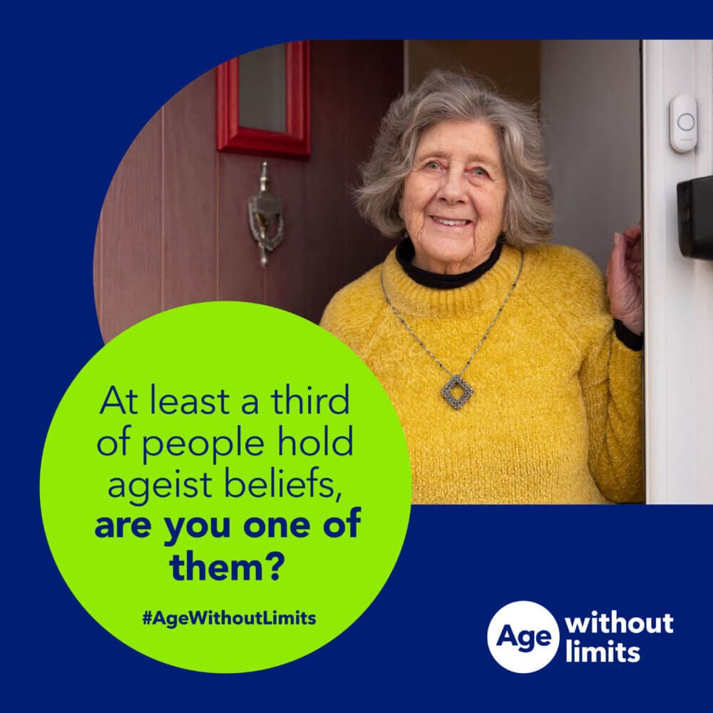 Smiling elderly woman in a yellow sweater stands at a doorway with text about ageism: "are you one of them?. - Home Instead