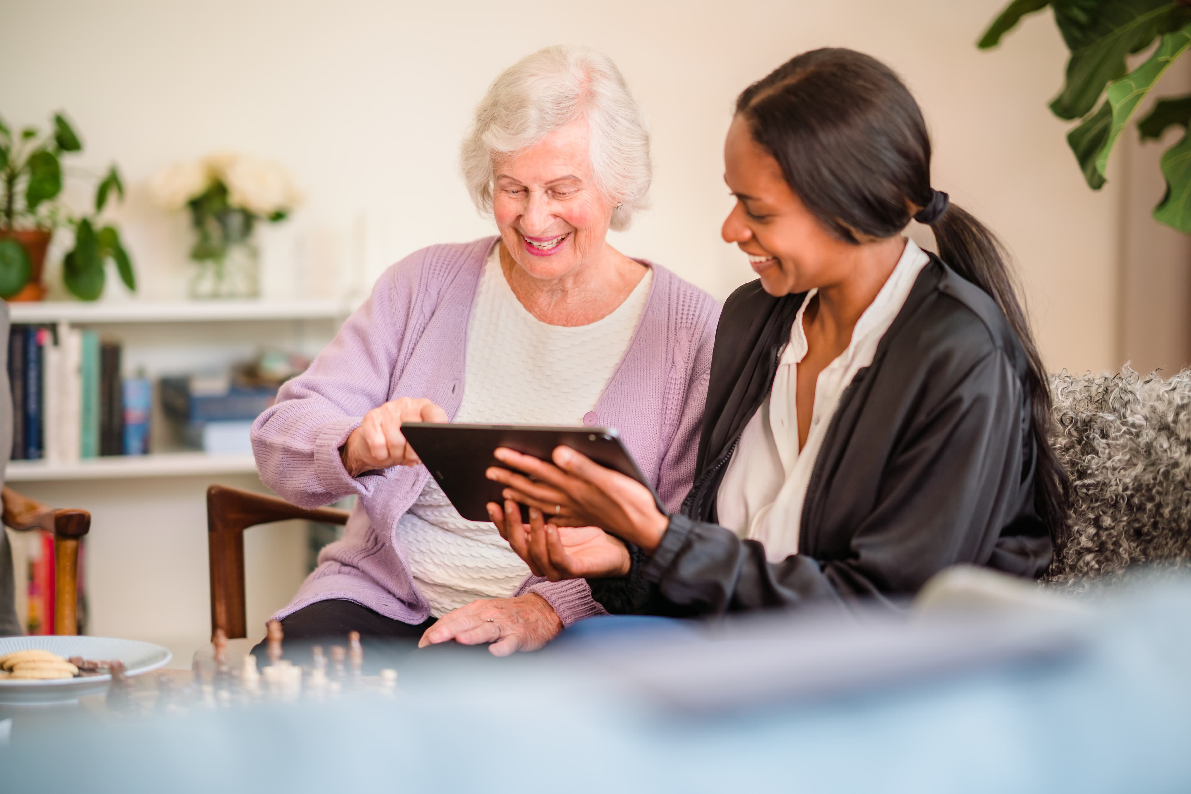 Care pro helping client to use a tab